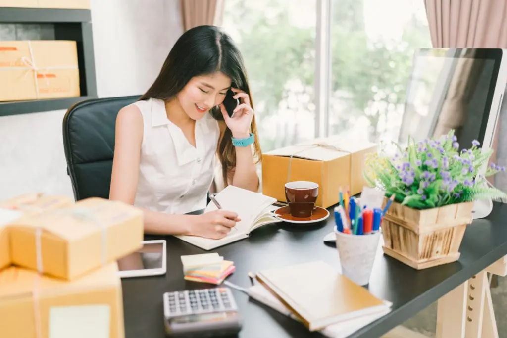 young woman sitting at home office desk