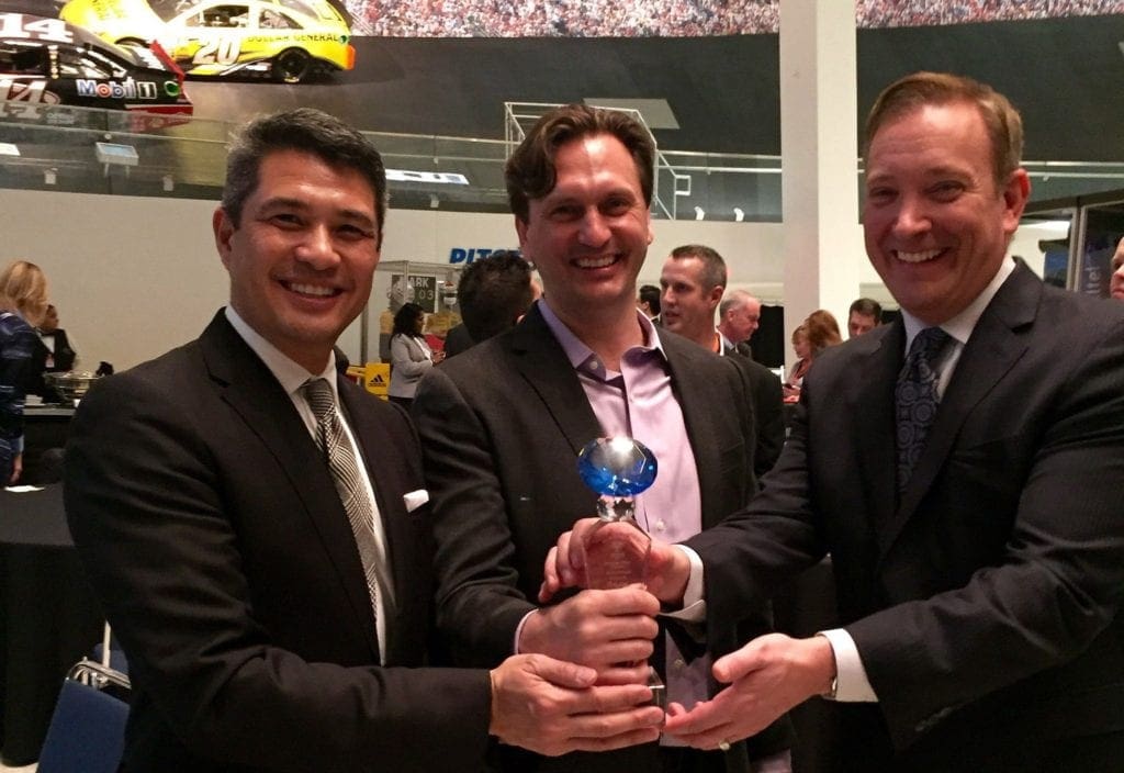 three AvidXchange leaders holding award