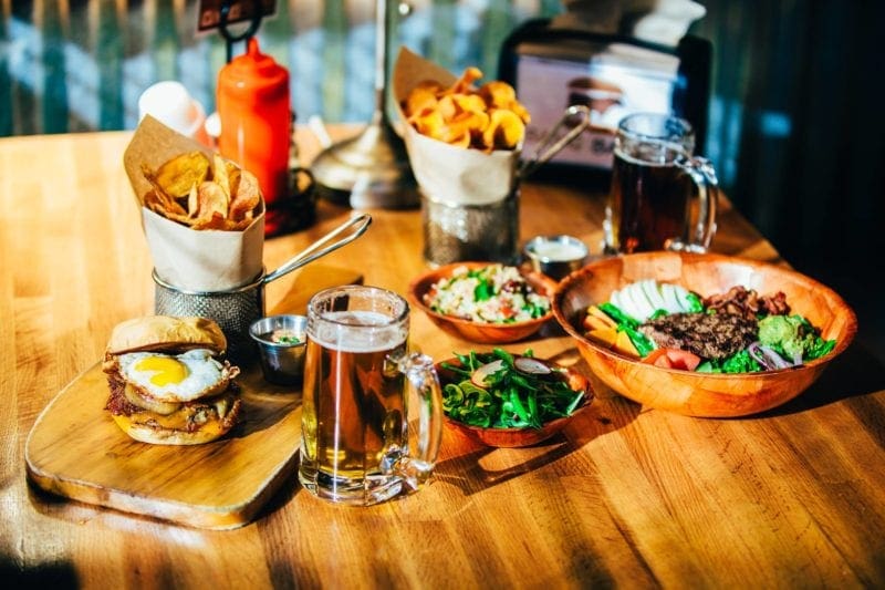 restaurant table with burgers and fries