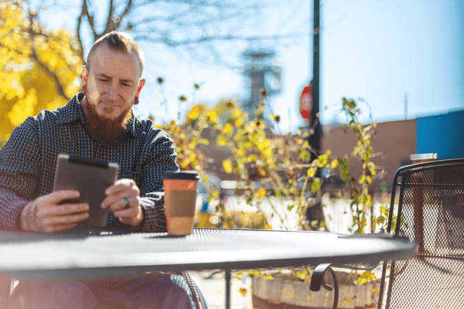man working outside at coffee shop