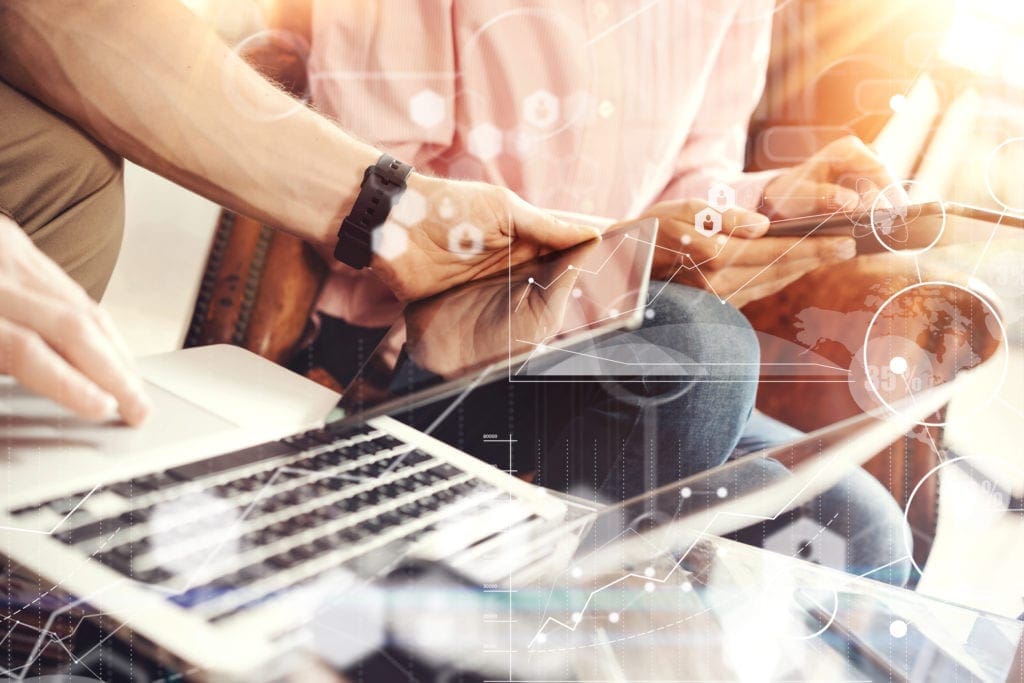 two people sitting at laptop