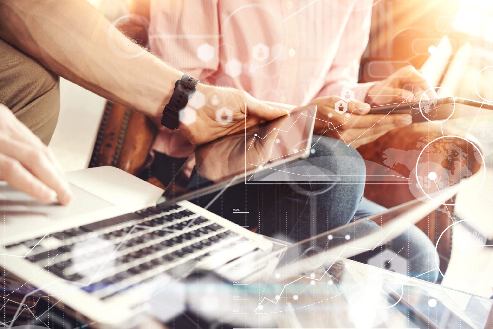 two people sitting at laptop