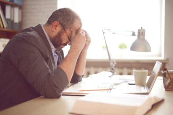 frustrated man sitting at desk