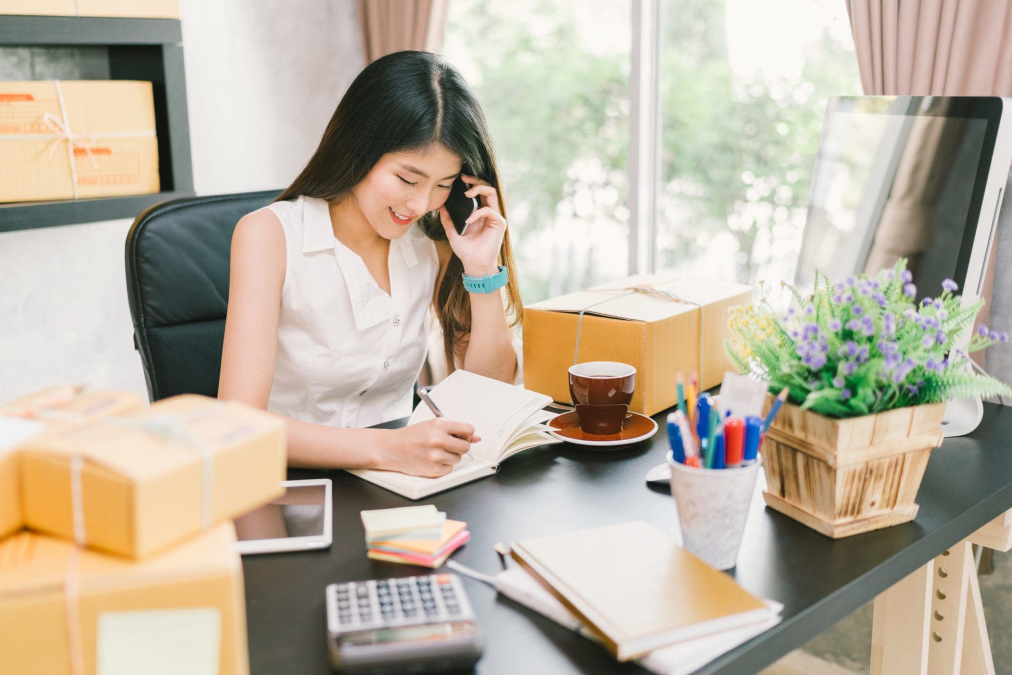 young woman sitting at home office desk