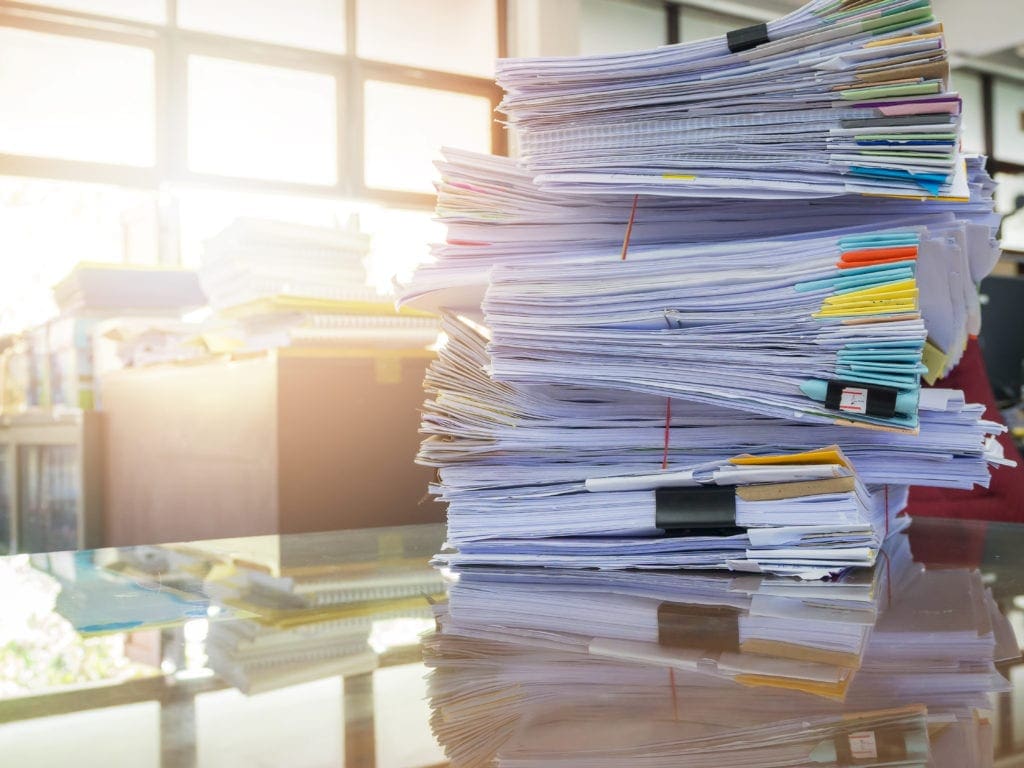 stack of papers on conference table