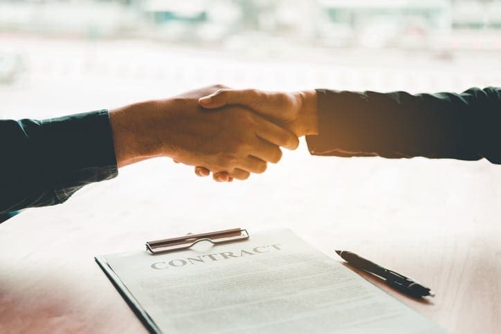 hand shake over contract documents