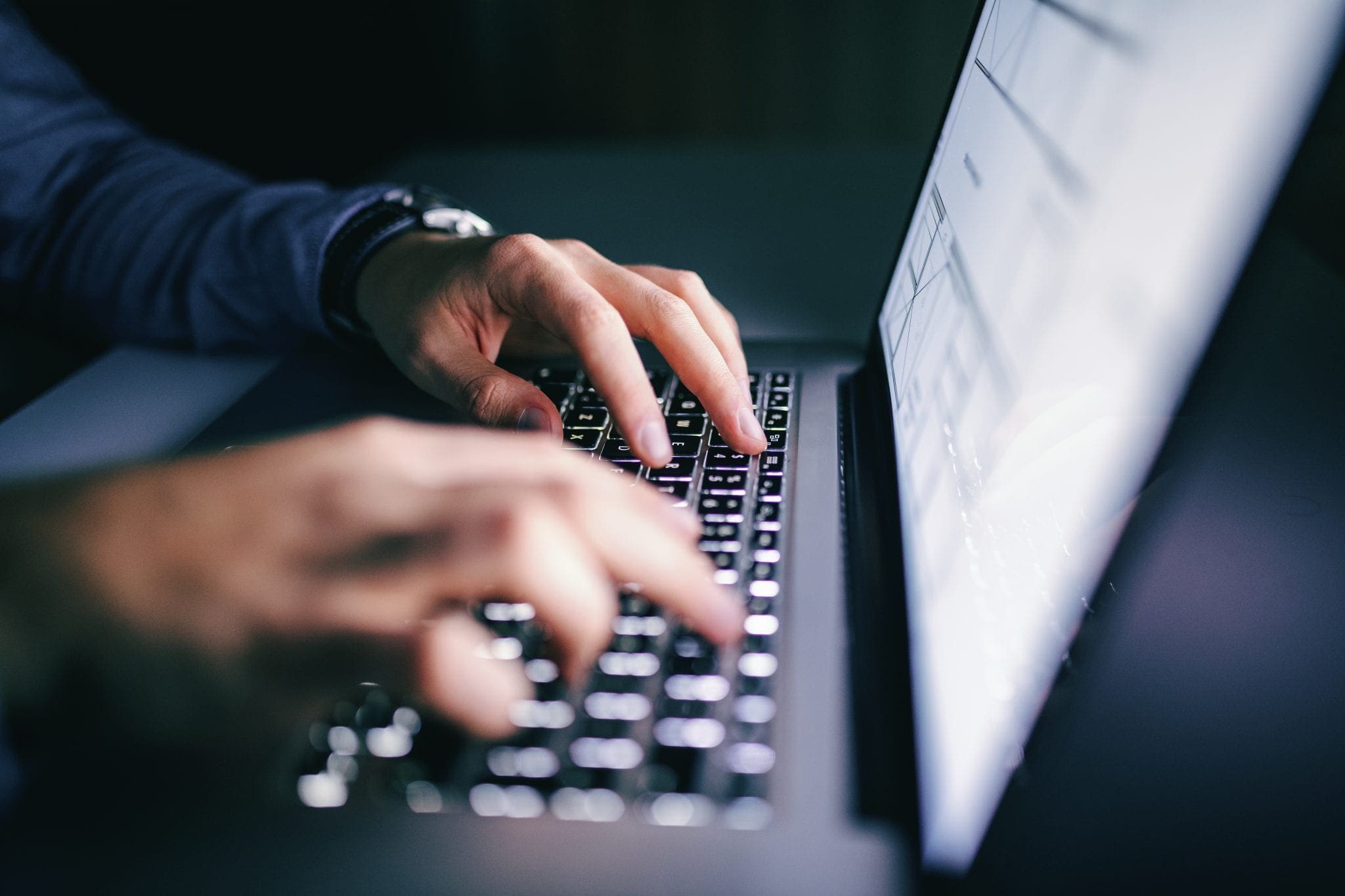 Close up of hands typing on laptop, used by AvidXchange for article about benefits of electronic invoicing and payments