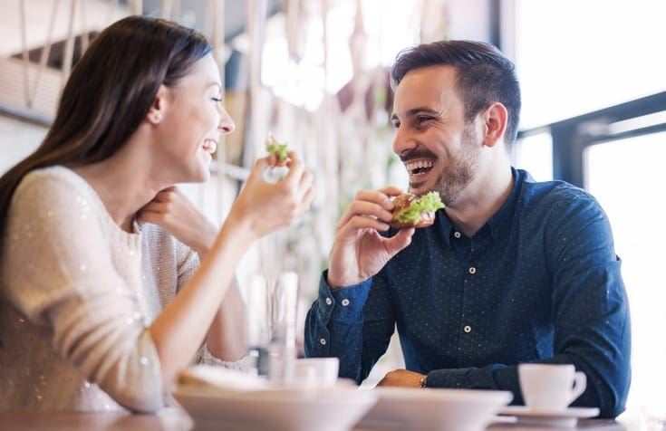 Beautiful young couple sitting in a cafe, used by AvidXchange for article about how Panera Bread Company improved accounts payable efficiency by automating their processes