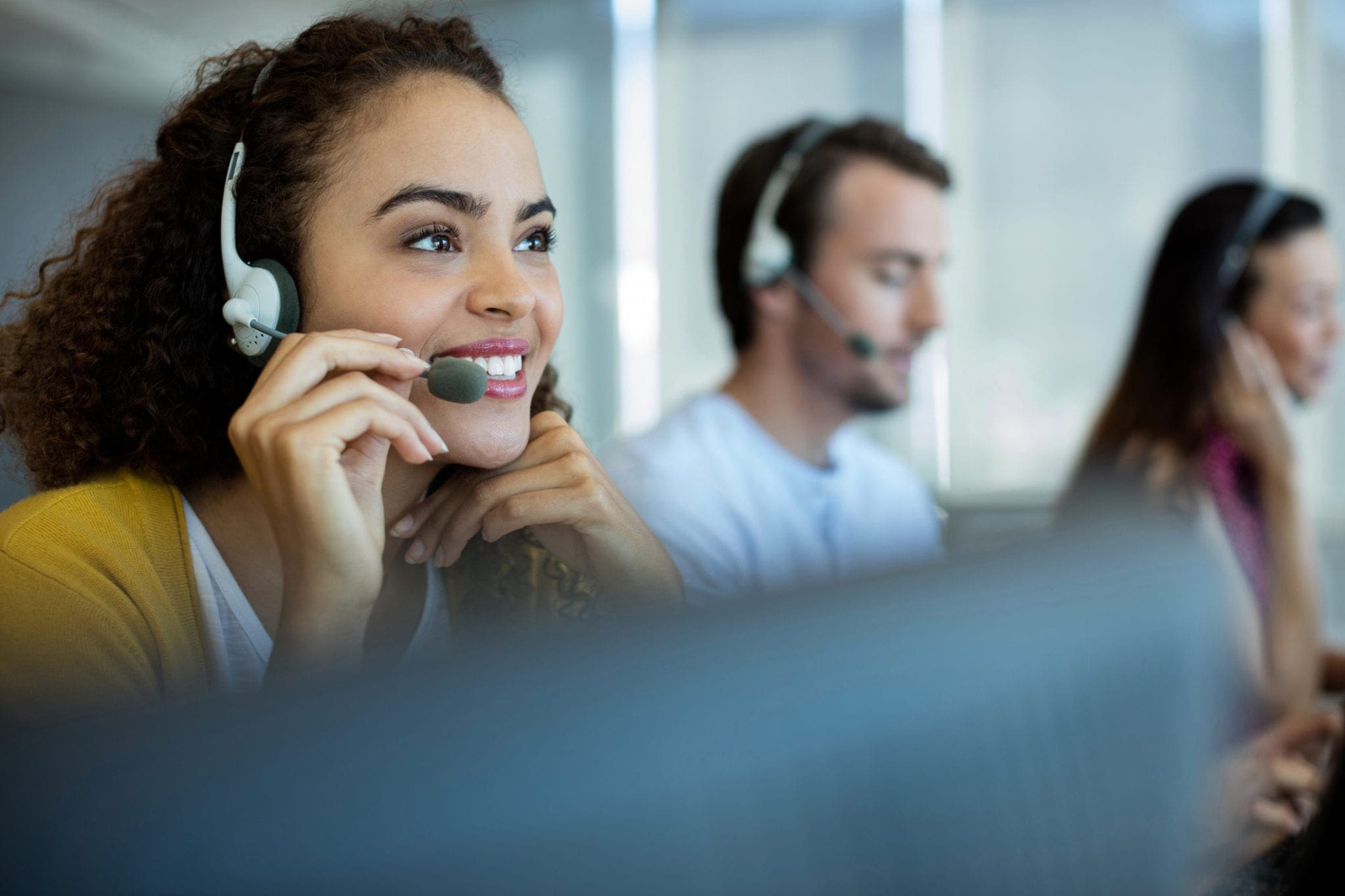 Customer service executive working at office, used by AvidXchange for article about how ap automation for community association management should combine services with technology