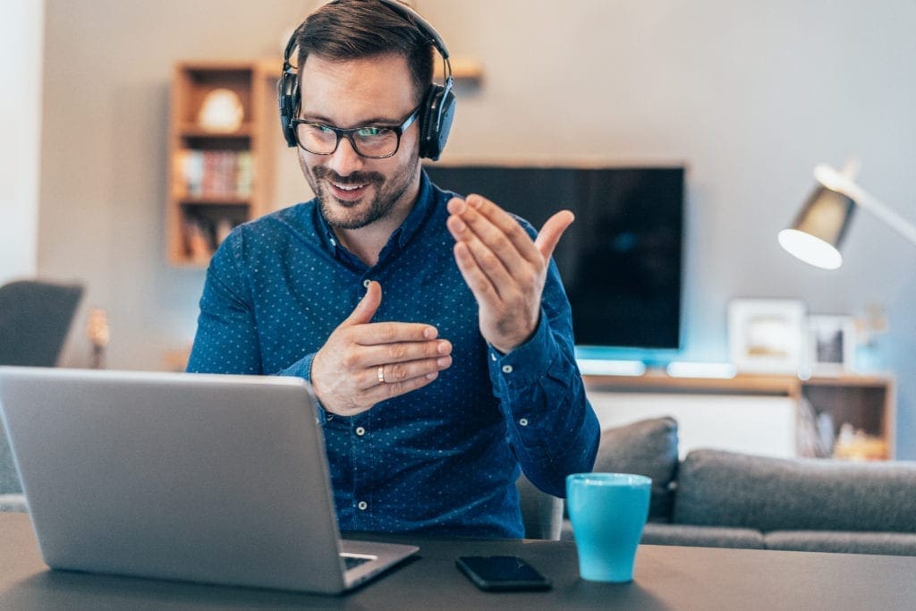 Man smiling working on his laptop