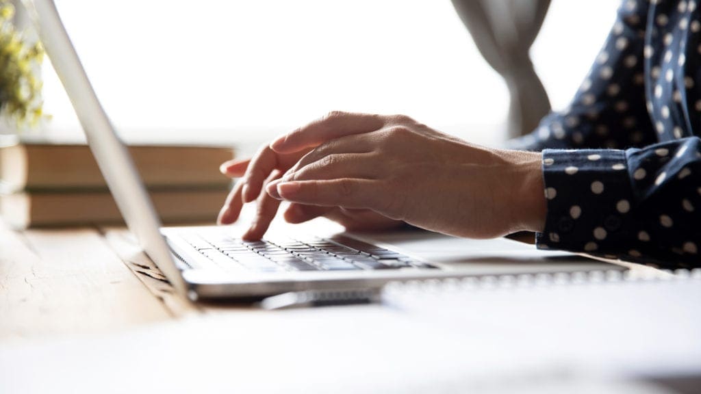 person typing on computer