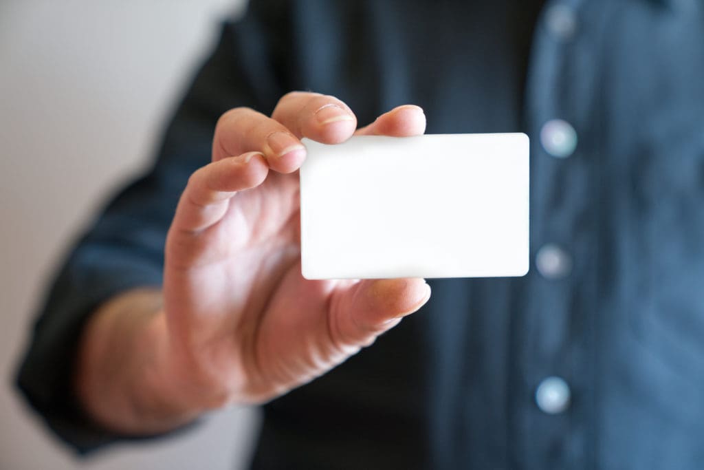 Hand holding blank white credit card