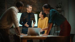Diverse Multiethnic Team are Having a Conversation in a Meeting Room Behind Glass Walls in a Creative Office.