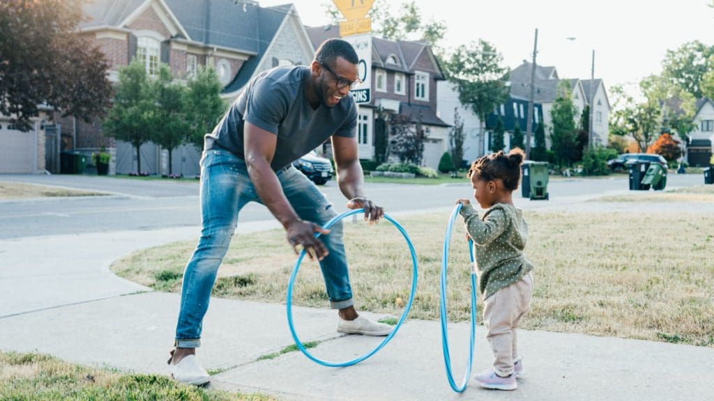 Father playing outside with daughter