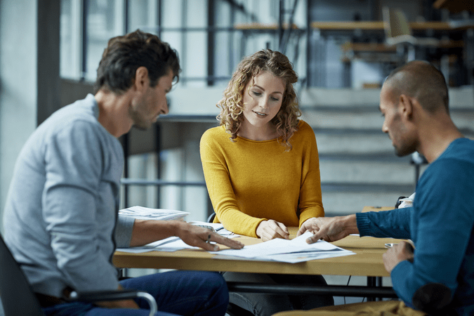 group of coworkers looking at papers together