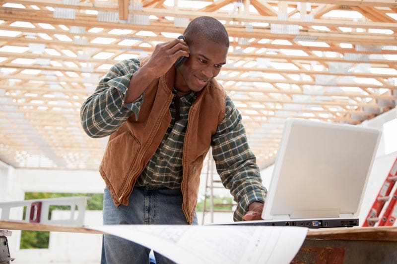 Foreman working on a laptop at the jobsite