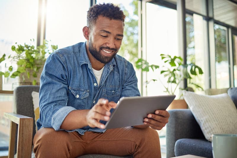 Young man using a tablet in his home office