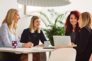 Group of female co-workers sitting around a table