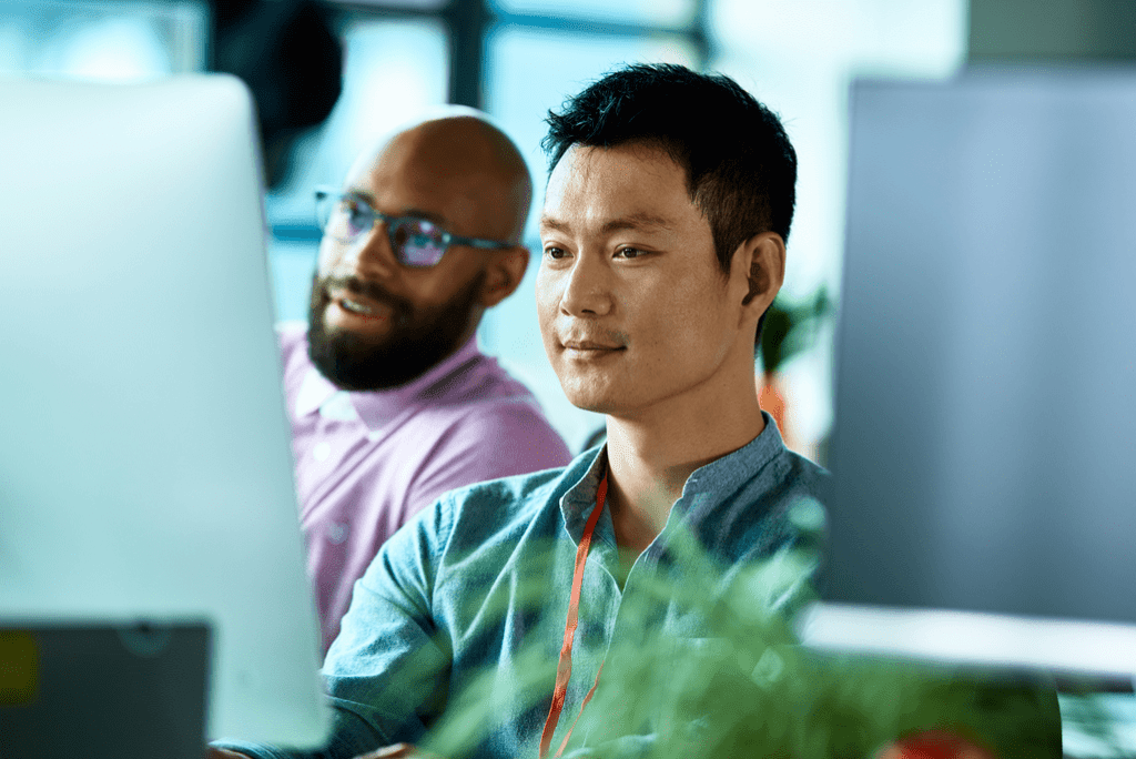 two men at work looking at a computer screen