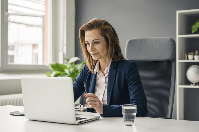 woman at desk working on laptop