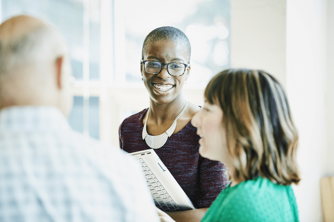 woman in office talking to coworkers