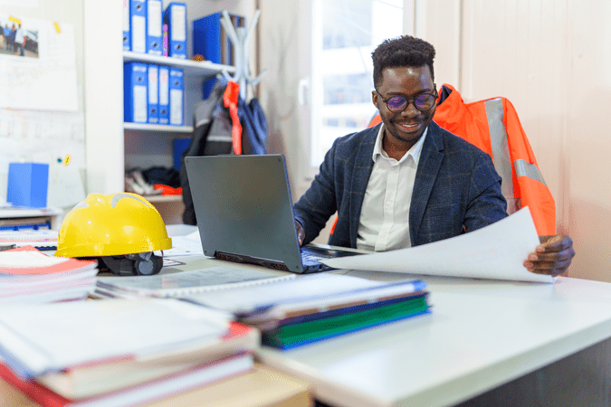 man at desk in construction office