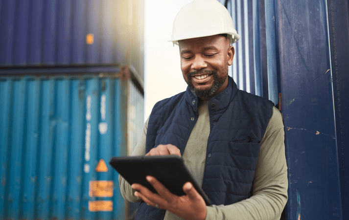 man in construction hat with a tablet