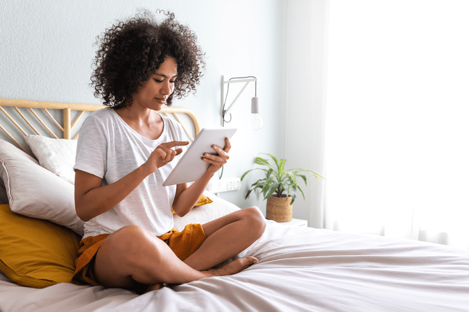 woman checking tablet working from home