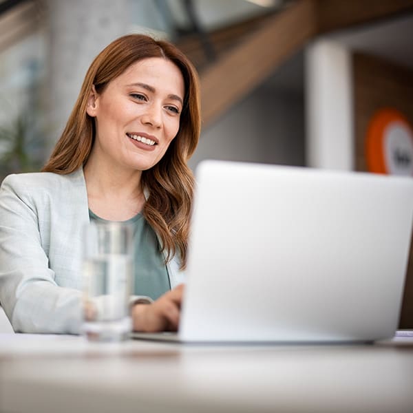 Smiling woman working on her laptop.