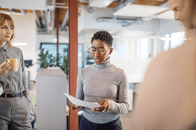 woman reading a paper at work