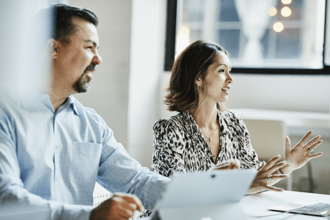 man and woman at a meeting at work
