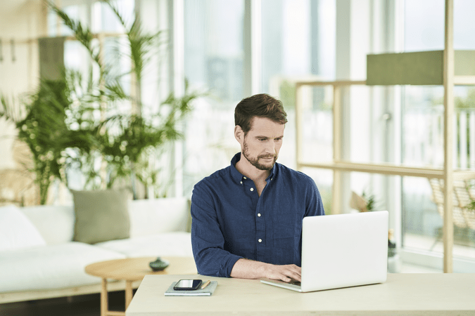 man at desk working on laptop