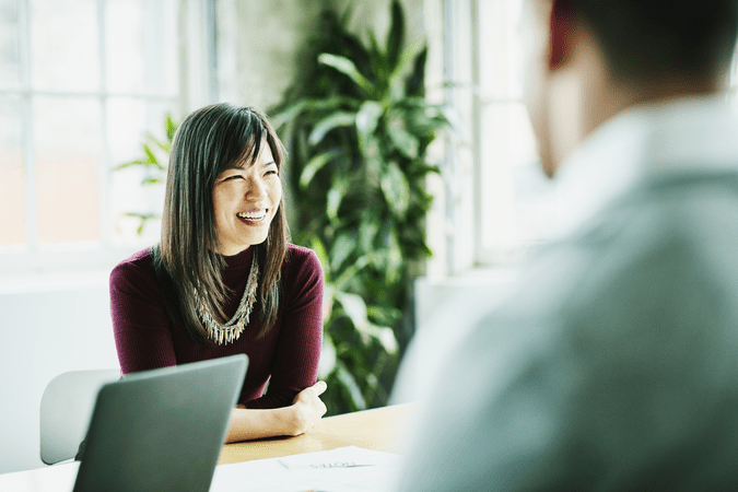 woman at meeting at work with laptop