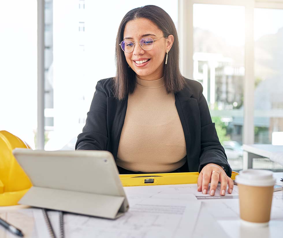 Woman working on her laptop and smiling.