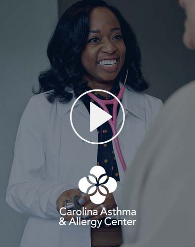 Carolina Asthma & Allergy Center employee smiling with a patient.