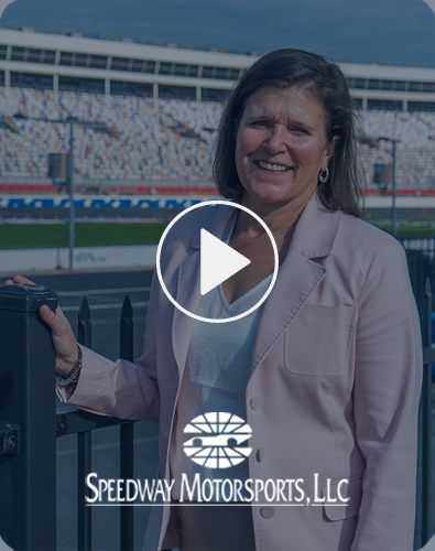 Sara Grafels standing by a gate at the speedway.