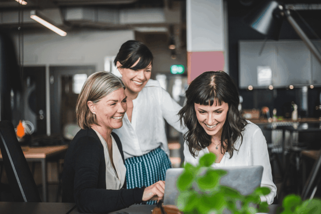 A team of three coworkers looking over data.