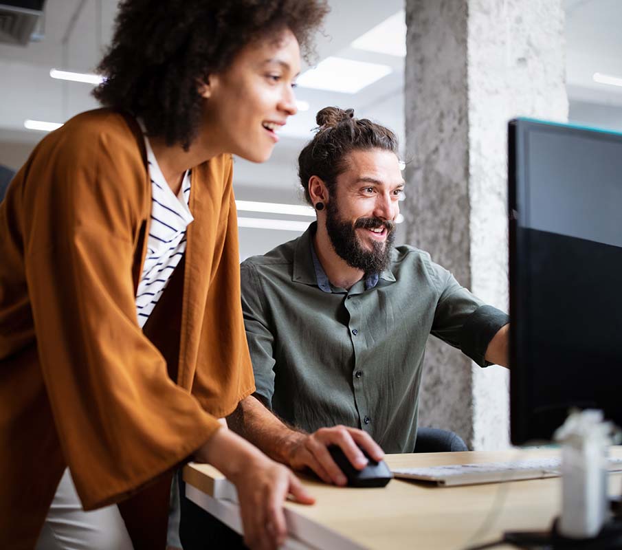 Coworkers looking at a computer screen.