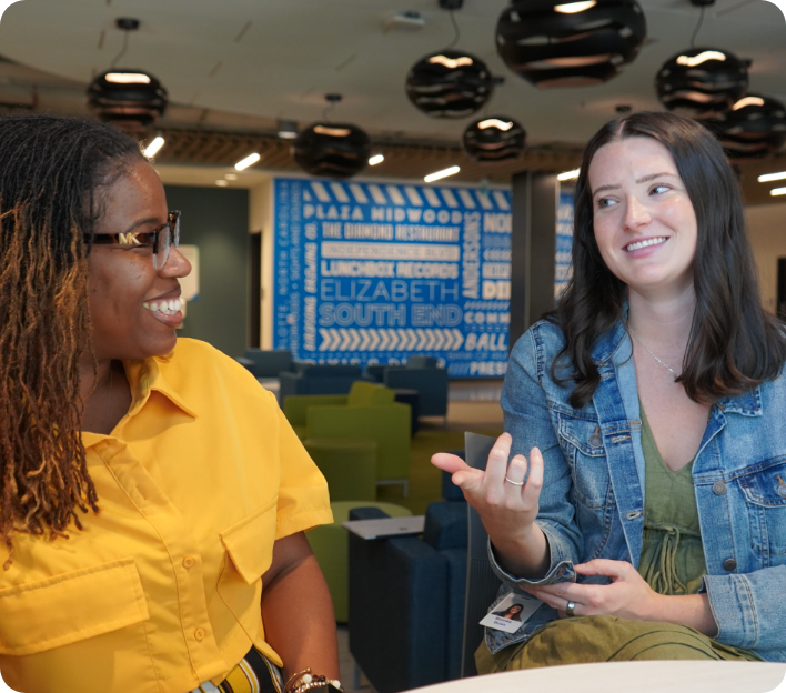 Two AvidXchange employees laughing with one another.