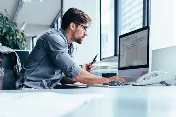 Real estate finance professional using ePayments at his desk in an office