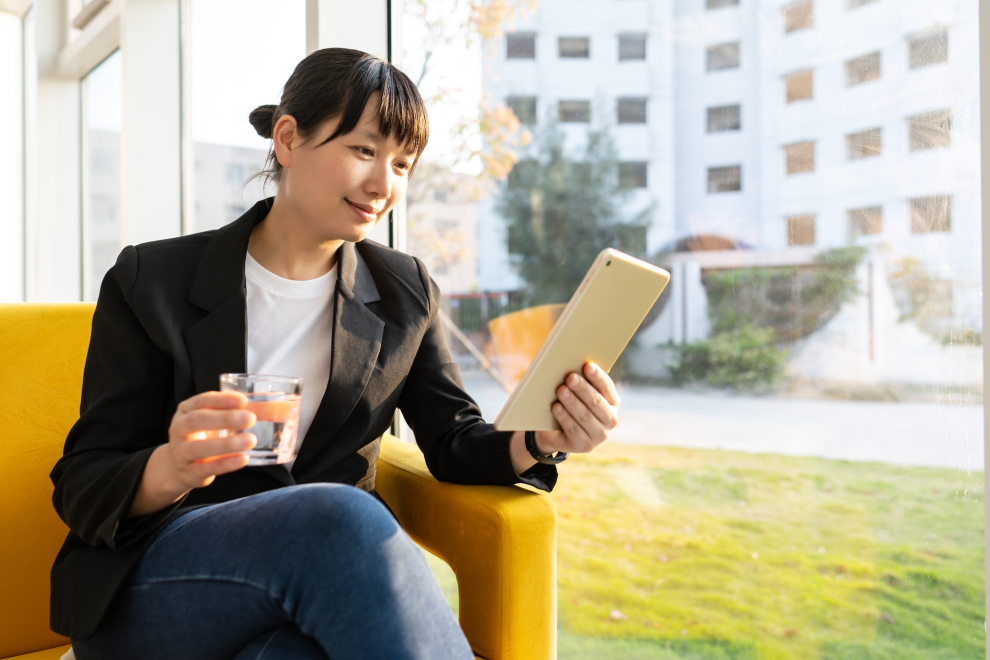 A business woman looking at a tablet computer and smiling